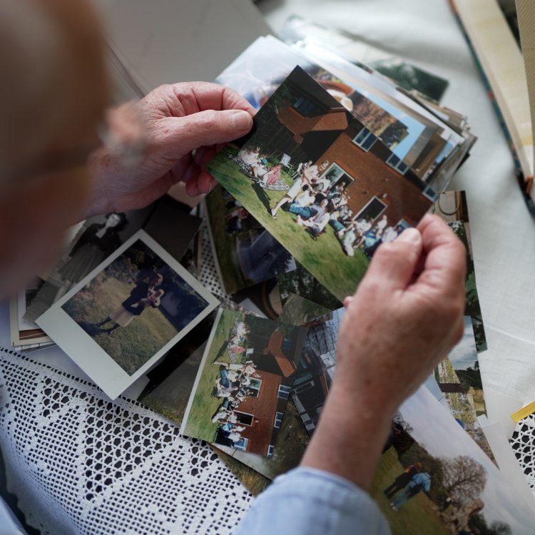 Time Capsule Film customer enjoying reminiscing with old photos - Video Memoirs